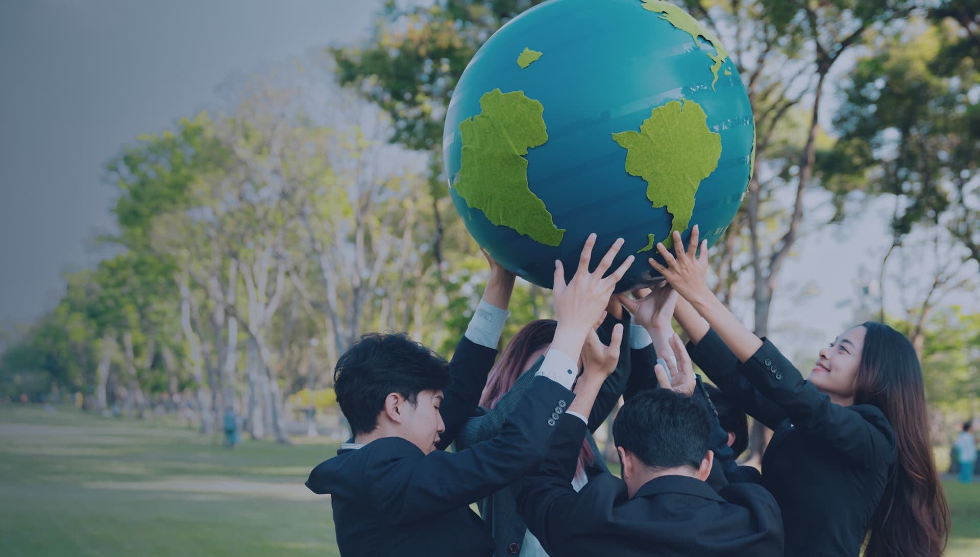 Students holding a globe together